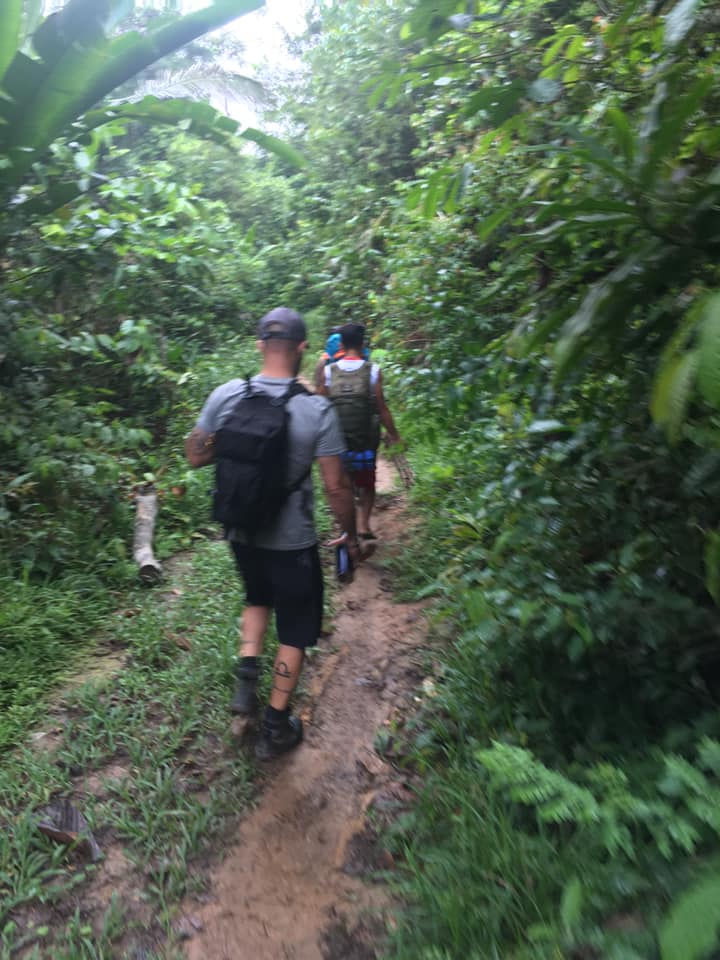 Traveler walking through an Amazon jungle path near Iquitos Peru