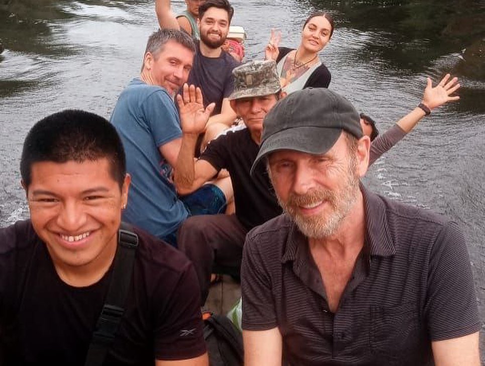 Friends traveling by boat in the Amazon near Iquitos Peru for an ayahuasca retreat